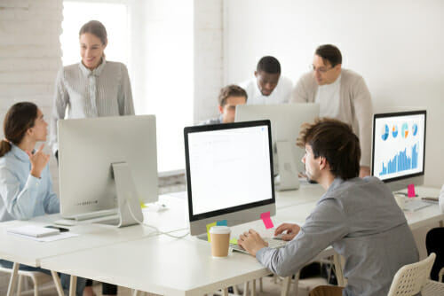 A group of people working in an open office environment 